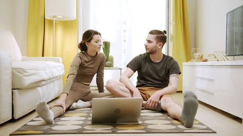 Young couple exercising at home