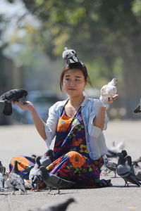 Portrait of woman with pigeons