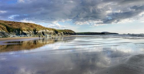 Scenic view of sea against cloudy sky