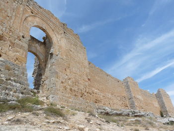 Low angle view of old ruins against sky