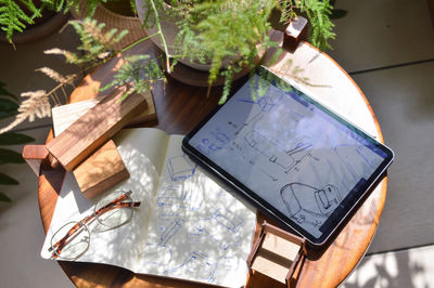 Furniture design, digital drawing in tablet and analog in notebook