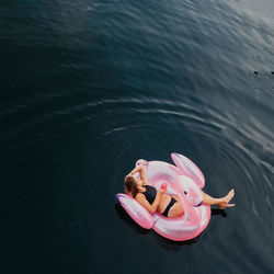 High angle view of woman laying down on inflatable
