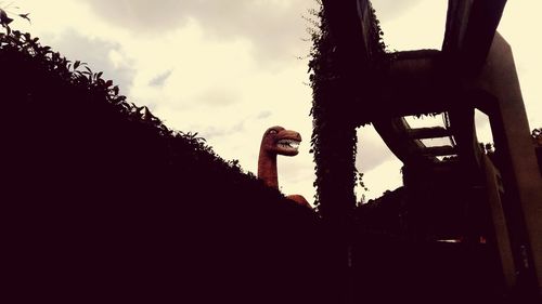 Low angle view of bird sculpture against sky