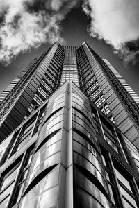 Low angle view of modern building against cloudy sky