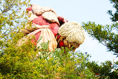 Low angle view of people at farm against sky