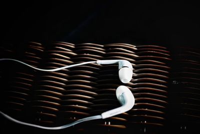 Close-up of headphones on wicker basket