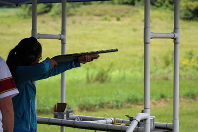 Woman aiming with rifle