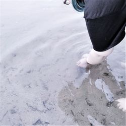 Cropped hands of woman in sea