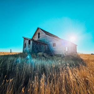 Abandoned farmhouse on a hill in the sun