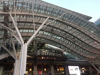 Low angle view of illuminated bridge against sky in city