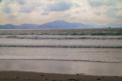 Scenic view of sea against cloudy sky