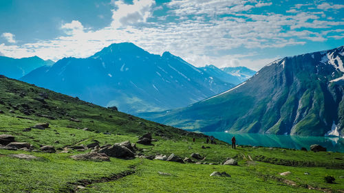 Scenic view of field and mountains against sky