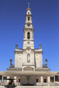 Low angle view of building against clear blue sky