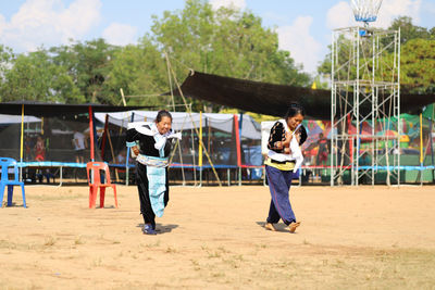 Full length of children playing on swing