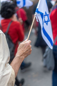 Midsection of man holding flag