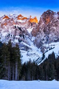 Scenic view of snow covered mountains against sky