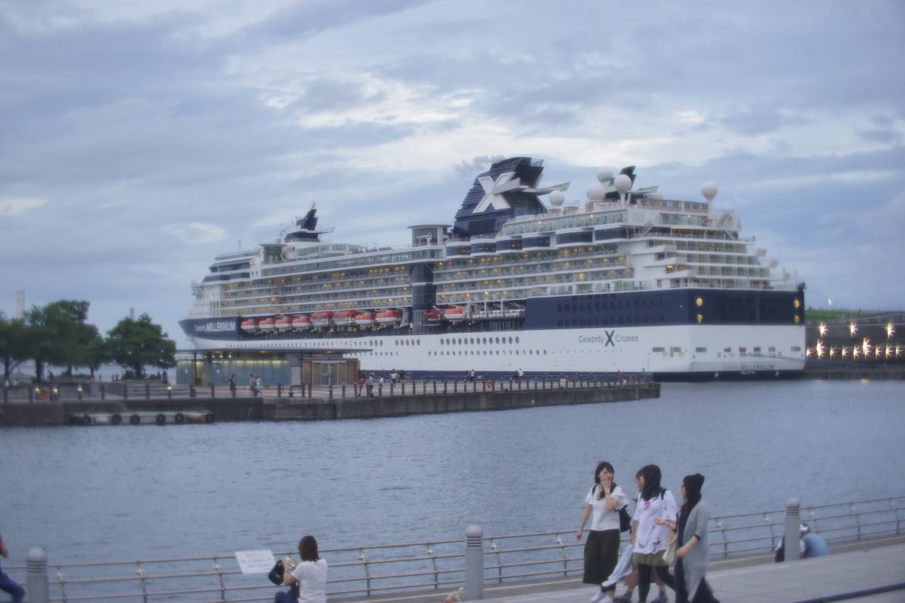 water, sky, sea, architecture, waterfront, cloud, calm, railing, person, cloud - sky, tranquility, tranquil scene, ocean, cruise ship, outdoors, day