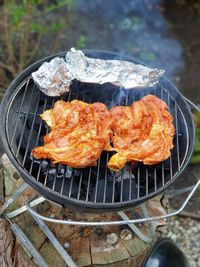 High angle view of meat on barbecue grill