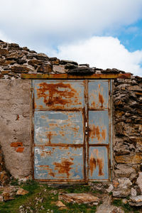 Graffiti on old wall against sky