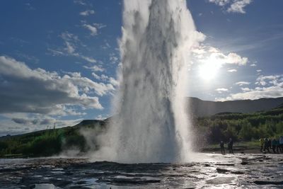 Scenic view of waterfall against sky