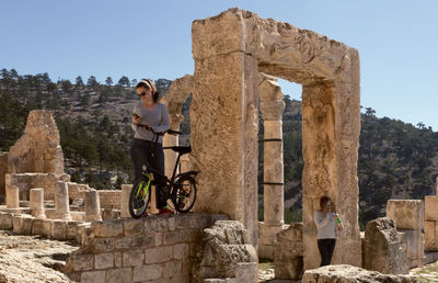 Friends by old ruins against mountain