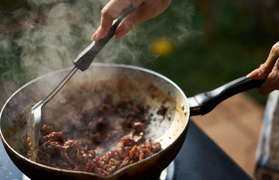 Cropped hands of person preparing food