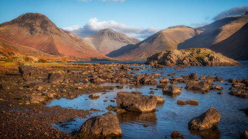 Scenic view of lake and mountains against sky