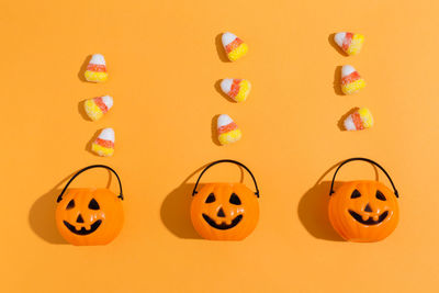 View of pumpkins against orange background