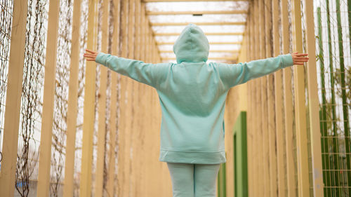 Rear view of man standing against wall