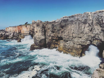 Scenic view of sea against clear blue sky