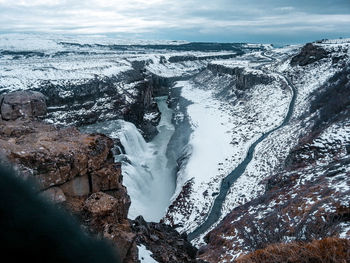 A waterfall, mountains and a road