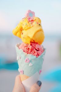 Close-up of hand holding ice cream cone