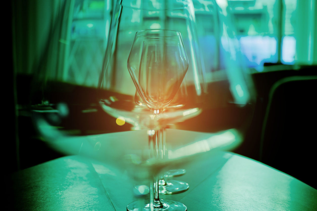 CLOSE-UP OF WINE GLASS ON TABLE AT RESTAURANT
