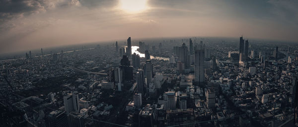 Aerial view of buildings in city during sunset