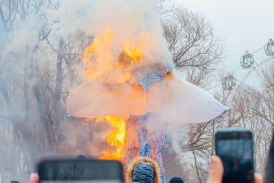 Panoramic view of people photographing against sky