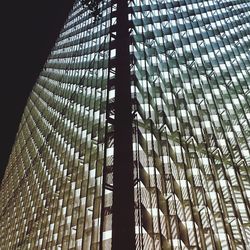 Low angle view of modern glass building against sky