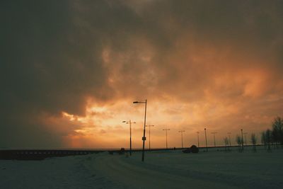 Scenic view of sea against cloudy sky at sunset