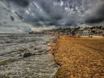 View of beach against cloudy sky