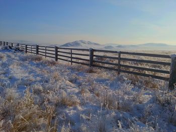 Scenic view of snowy landscape against clear sky