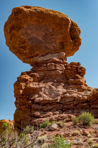 Low angle view of rock formation against blue sky