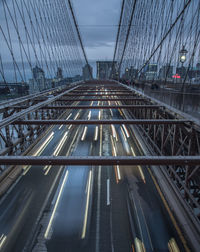 High angle view of light trails on bridge in city against sky