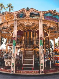 Low angle view of carousel against sky