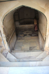 High angle view of woman standing on staircase in building