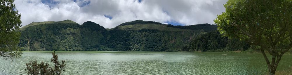 Panoramic view of lake and trees against sky