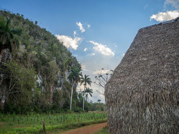 View of field against cloudy sky