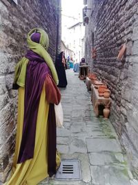 Rear view of women on wall