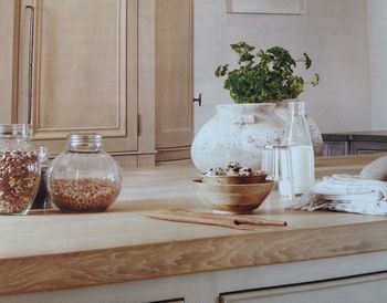 Food served in bowl by containers on kitchen counter