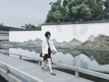 Young woman standing on footbridge