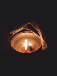 Close-up of illuminated lamp in darkroom