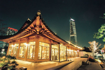 Illuminated building against sky at night